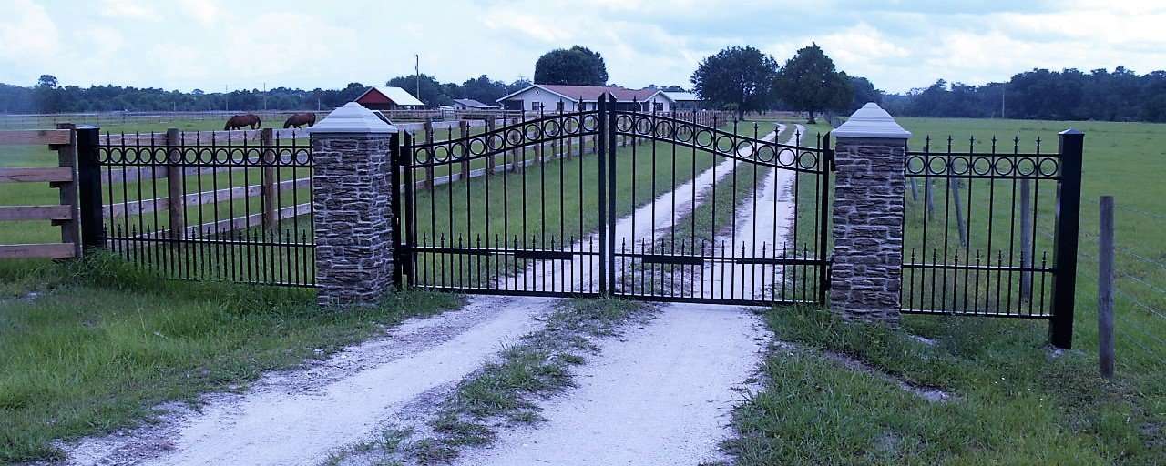 A gate that is open on the side of a road.