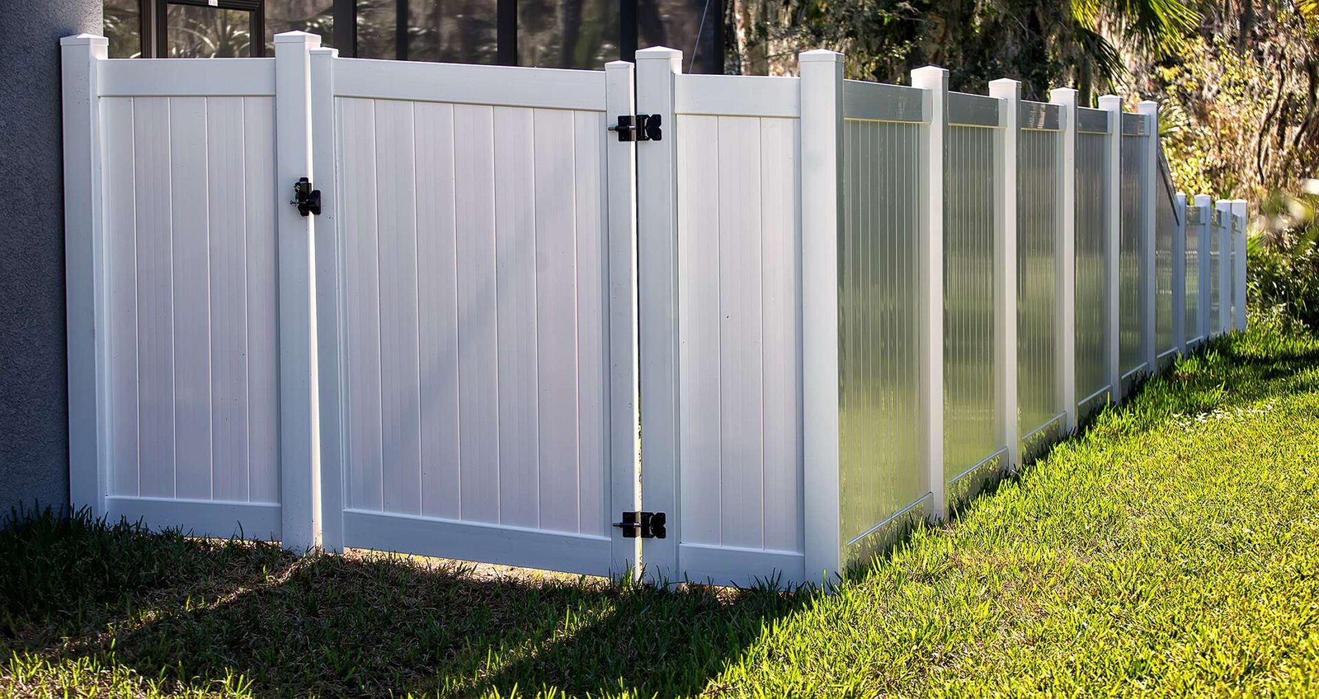 A white fence with two gates on each side.