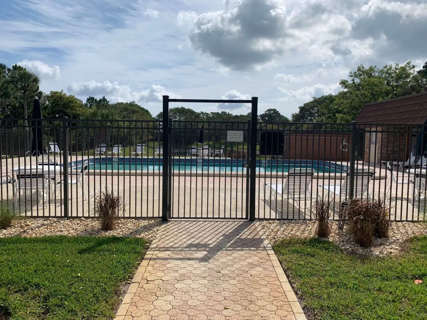 A gated entrance to an empty pool.