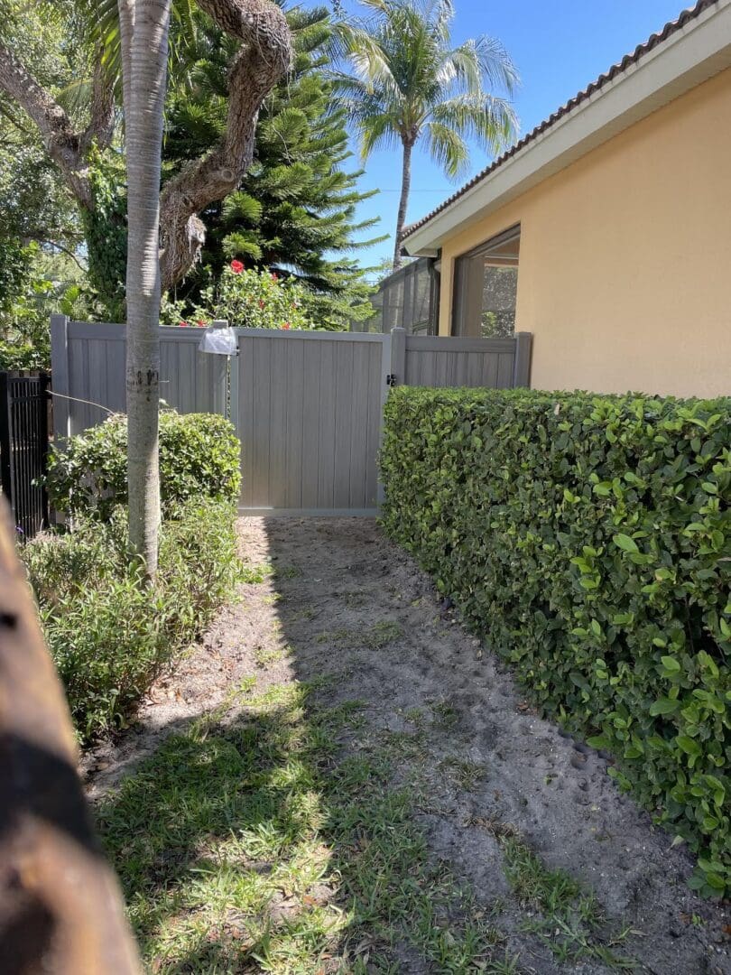 Gray fence gate, backyard pathway.