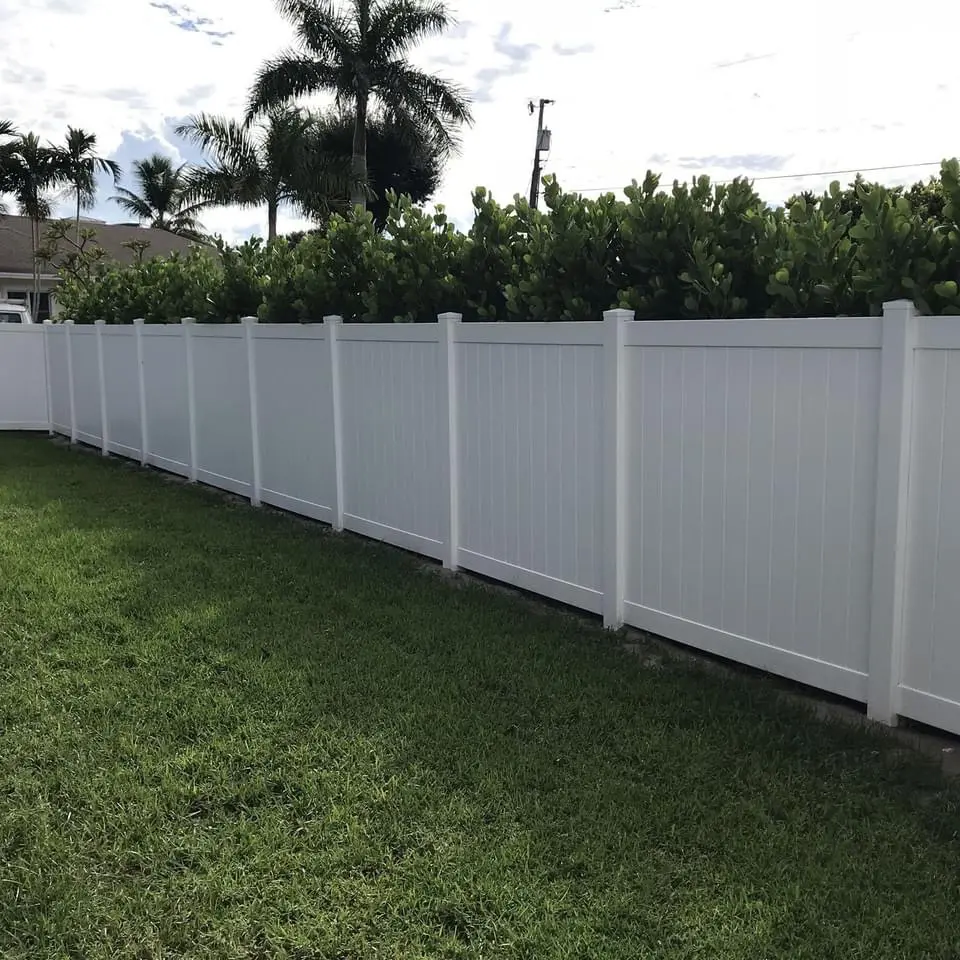 White vinyl fence in backyard.