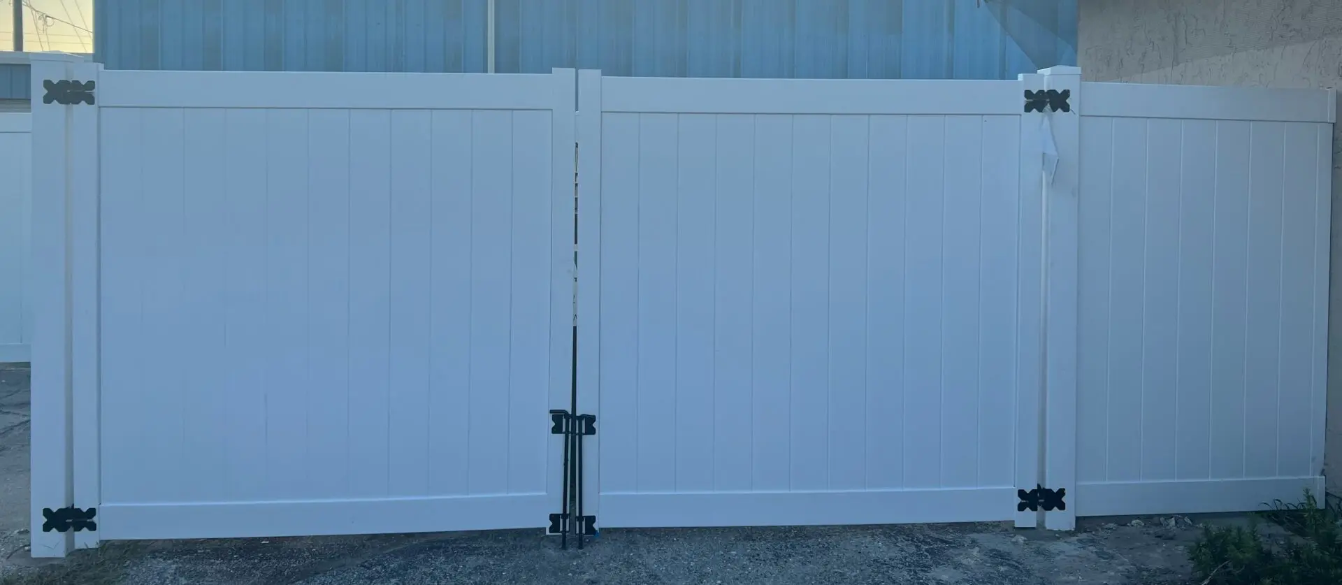 White vinyl fence with black hinges.