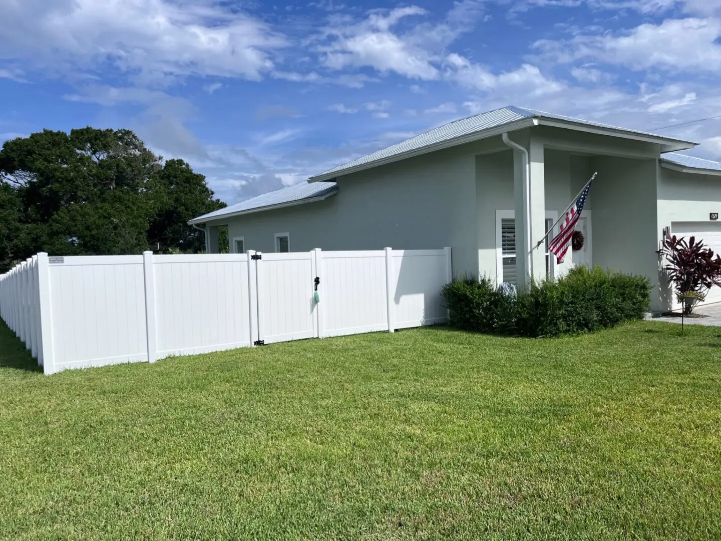 White vinyl fence around a house.