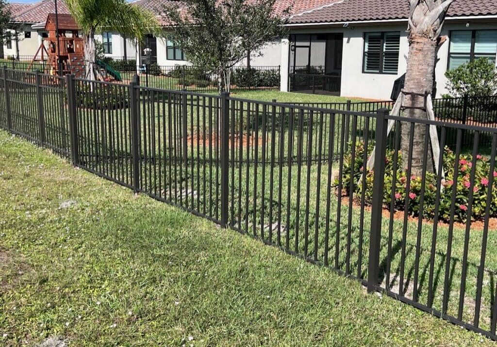 Black metal fence in front of a house.