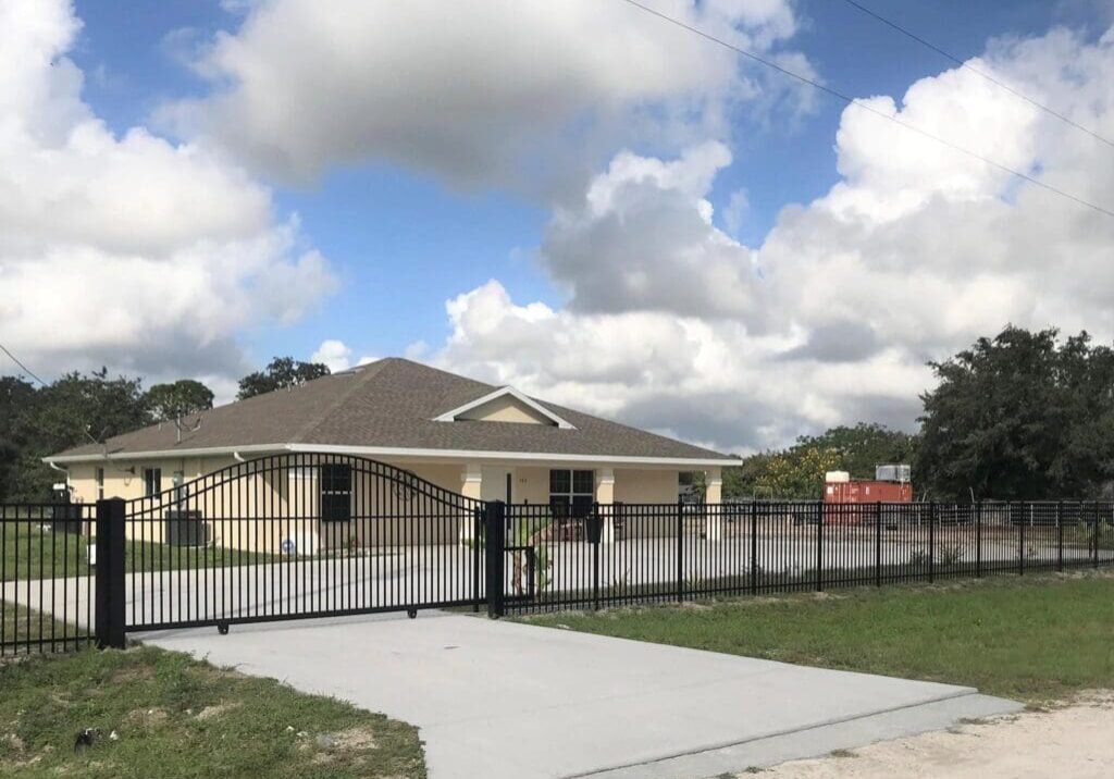 New house with black fence and gate.